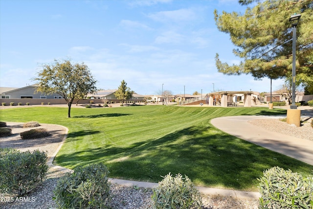 view of home's community with a yard