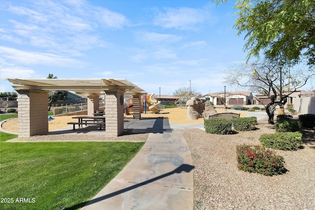 view of community featuring playground community and a yard