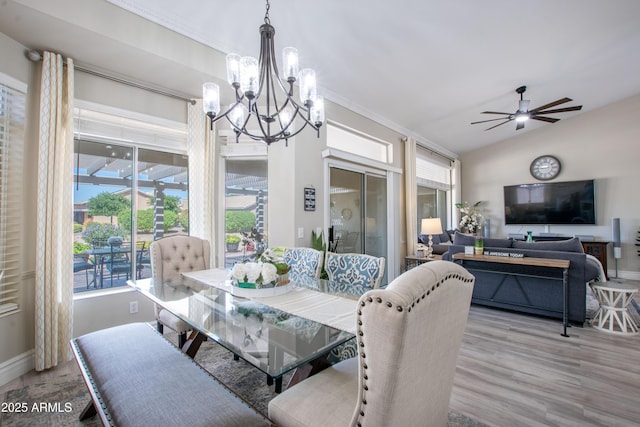 dining space featuring baseboards, wood finished floors, and a healthy amount of sunlight