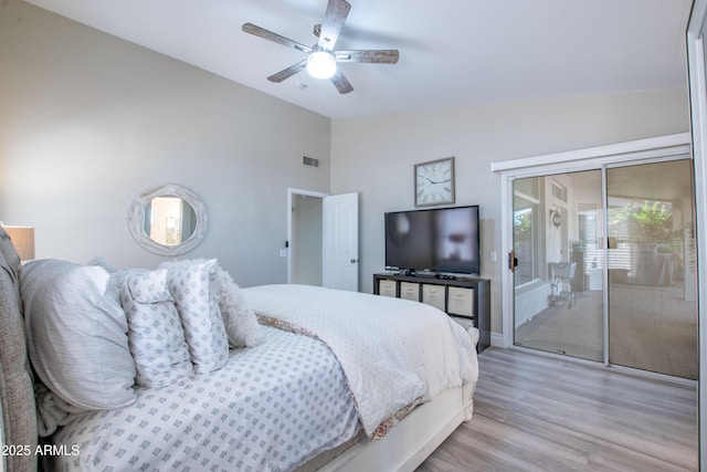 bedroom featuring access to outside, ceiling fan, wood finished floors, lofted ceiling, and visible vents