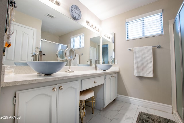 full bath with a sink, visible vents, a shower stall, and marble finish floor