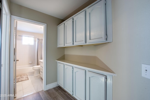 hallway featuring baseboards