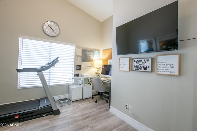 home office with baseboards, light wood finished floors, and high vaulted ceiling