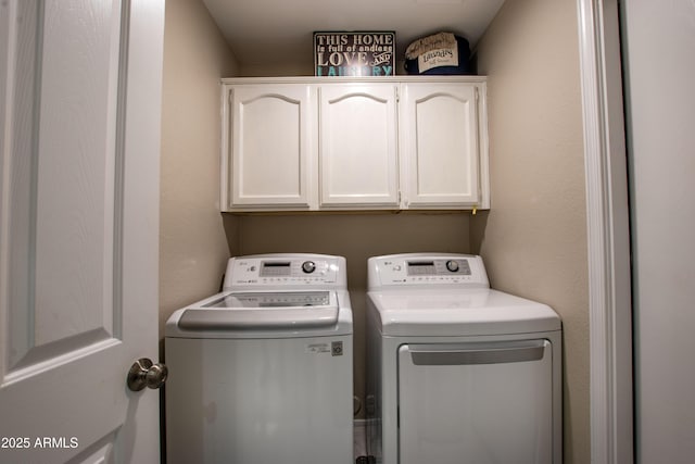 laundry area featuring washer and dryer and cabinet space