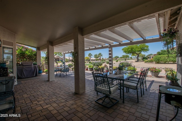 view of patio featuring grilling area, a pergola, and outdoor dining area