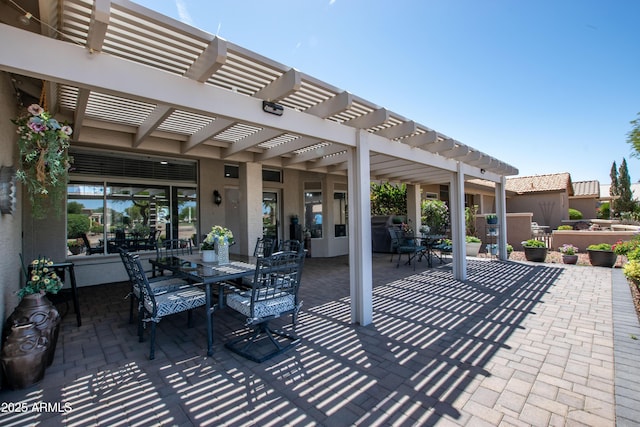 view of patio featuring a pergola and outdoor dining area