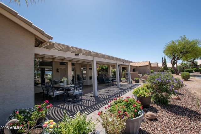 view of patio with a pergola and outdoor dining area