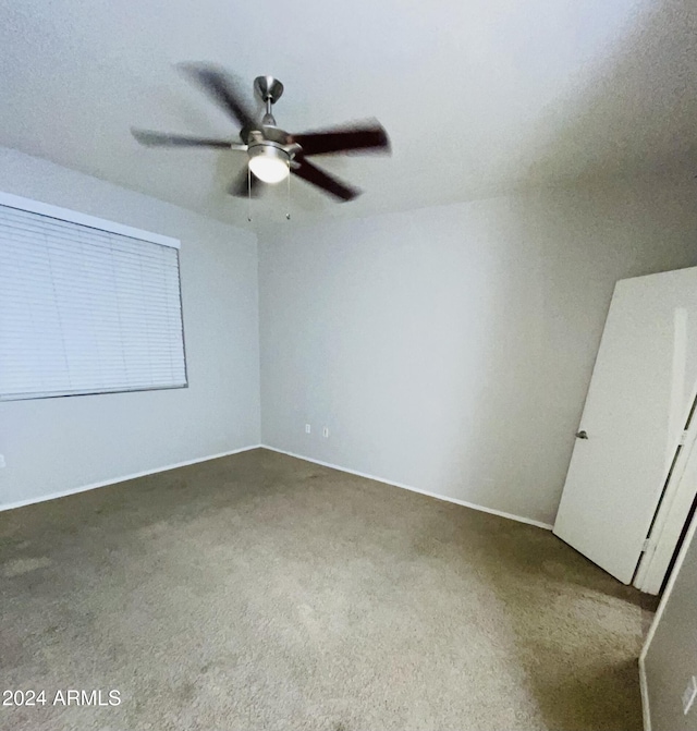 unfurnished bedroom with ceiling fan and carpet floors