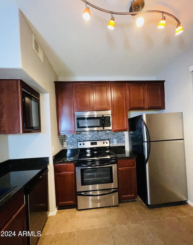 kitchen with stainless steel appliances, light tile patterned floors, and tasteful backsplash