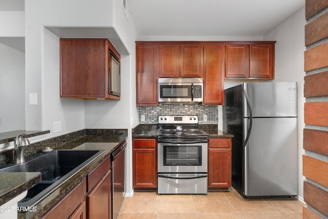 3302 N 7th St Unit 226, Phoenix, AZ 85014 - kitchen featuring appliances with stainless steel finishes, dark stone countertops, and backsplash