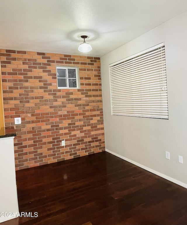 spare room featuring dark wood-type flooring