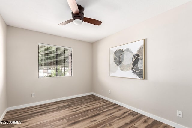 unfurnished room with a ceiling fan, baseboards, and wood finished floors