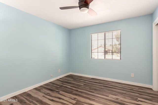 unfurnished room featuring dark wood-style floors, baseboards, and a ceiling fan