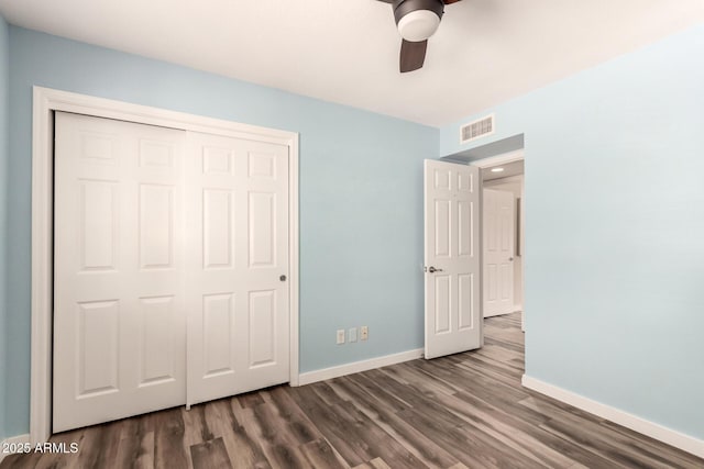 unfurnished bedroom with baseboards, visible vents, and dark wood-style flooring