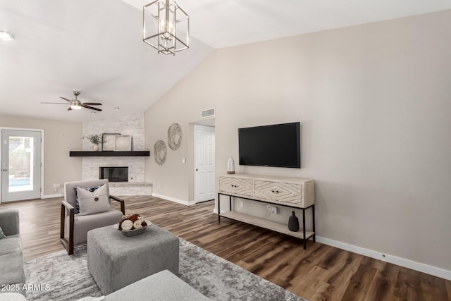 living room with a fireplace, wood finished floors, visible vents, and baseboards