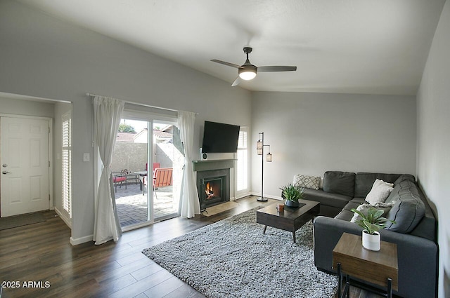 living room featuring dark hardwood / wood-style flooring, lofted ceiling, and ceiling fan