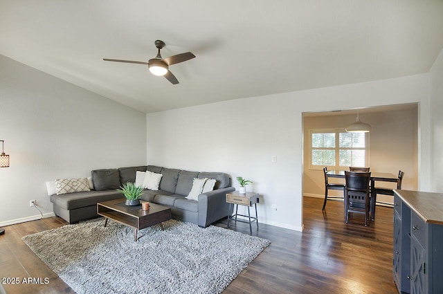 living room with dark wood-type flooring and ceiling fan