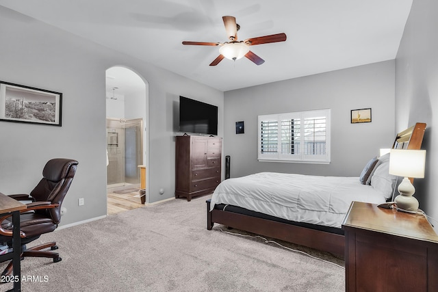 carpeted bedroom featuring ceiling fan and connected bathroom