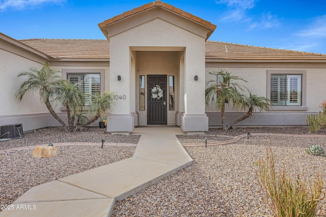 property entrance featuring central AC unit