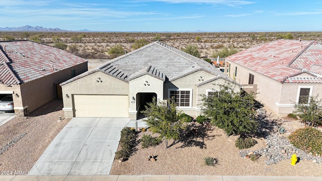 view of front facade featuring a mountain view and a garage