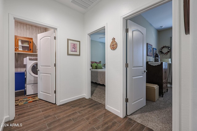 corridor featuring dark hardwood / wood-style floors and washer / clothes dryer