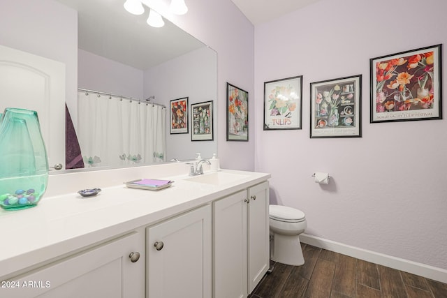 bathroom featuring hardwood / wood-style floors, vanity, and toilet