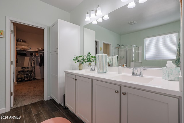 bathroom with hardwood / wood-style floors, vanity, and walk in shower