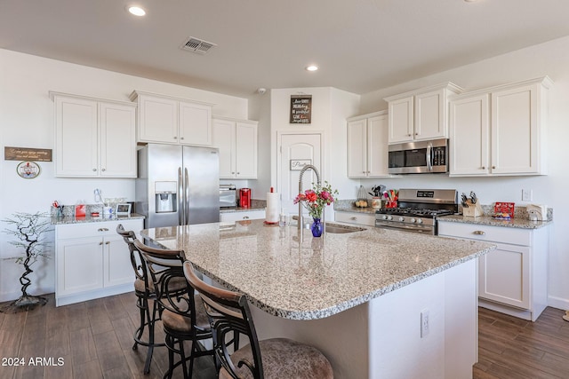 kitchen with dark hardwood / wood-style flooring, white cabinetry, and appliances with stainless steel finishes