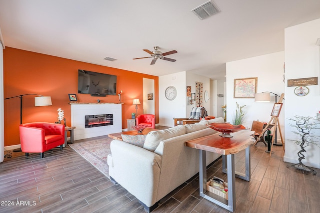 living room featuring dark hardwood / wood-style flooring and ceiling fan