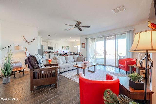 living room with ceiling fan and dark hardwood / wood-style floors