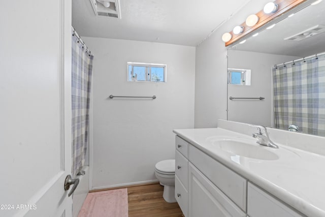 bathroom featuring curtained shower, vanity, toilet, and hardwood / wood-style flooring