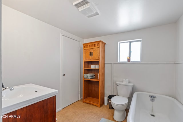 bathroom featuring vanity, a bathtub, and toilet