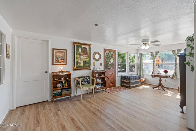 sunroom / solarium featuring ceiling fan