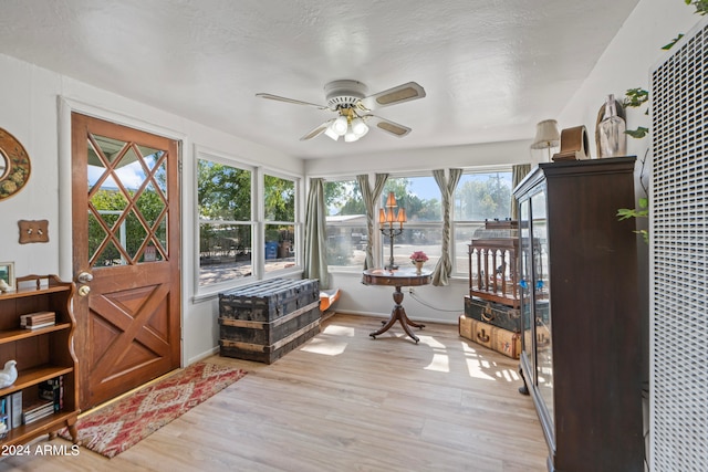 sunroom with ceiling fan and a healthy amount of sunlight