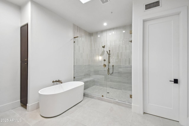 bathroom with a soaking tub, visible vents, a shower stall, tile patterned flooring, and baseboards