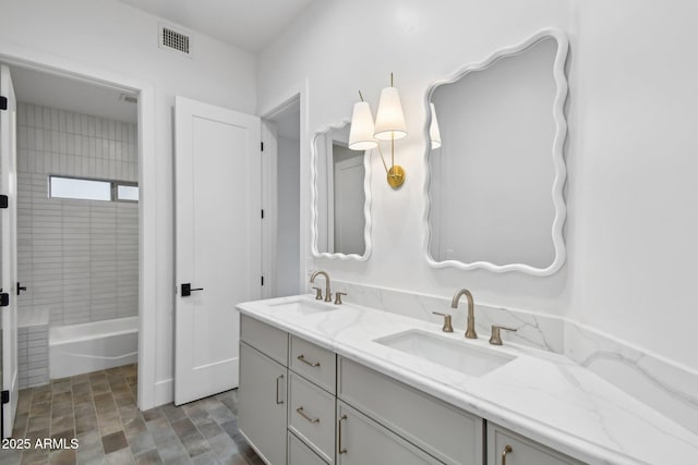 full bathroom with bathtub / shower combination, visible vents, a sink, and double vanity