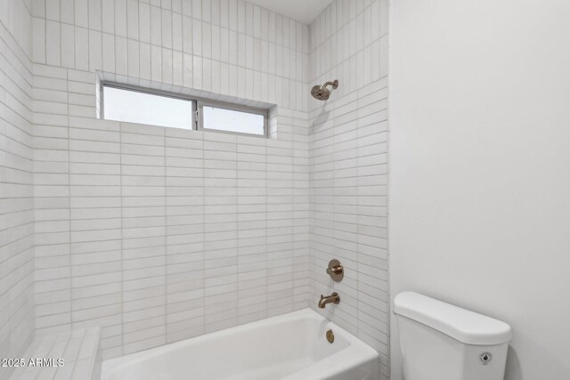 bathroom featuring shower / tub combination and toilet