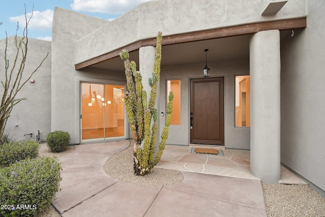 property entrance with stucco siding