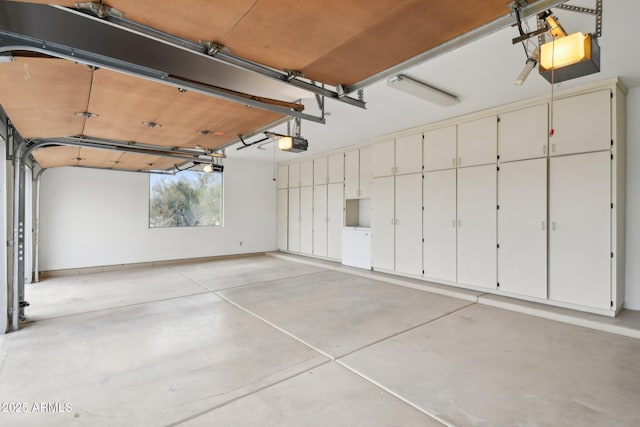 garage featuring baseboards and a garage door opener