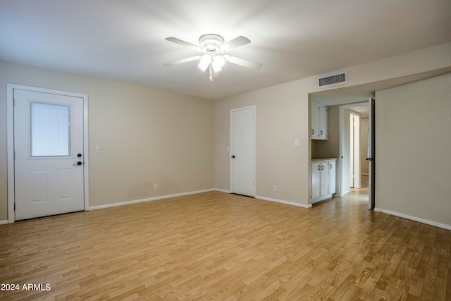 spare room featuring light hardwood / wood-style floors and ceiling fan