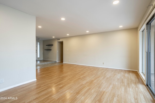 unfurnished room with light wood-type flooring