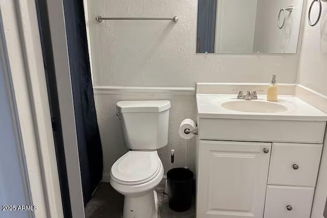 bathroom featuring vanity and toilet