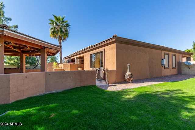 rear view of property featuring a yard