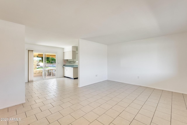 unfurnished room with light tile patterned floors