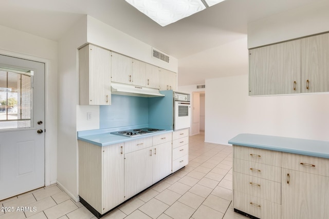 kitchen with light tile patterned floors and white appliances