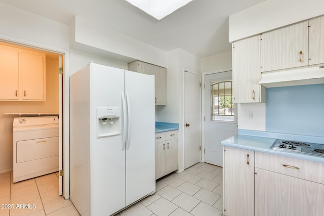 kitchen with light tile patterned flooring, washer / dryer, and white appliances