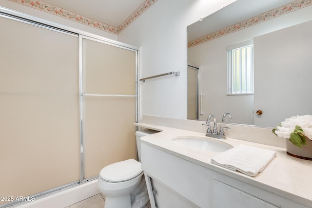 bathroom featuring vanity, toilet, and walk in shower