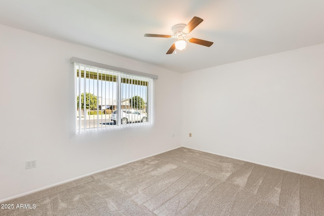 empty room with ceiling fan and carpet flooring