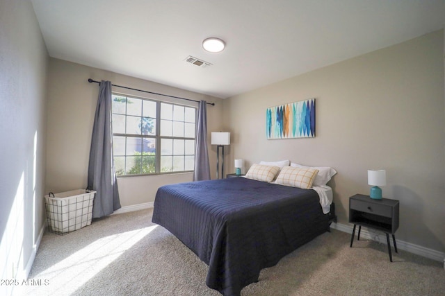 carpeted bedroom featuring baseboards and visible vents