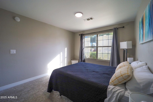 carpeted bedroom with baseboards and visible vents